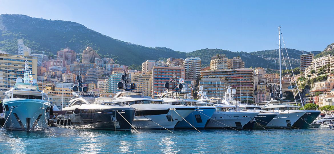 Yachts moored in Monaco harbour  with Monaco landscape on a back